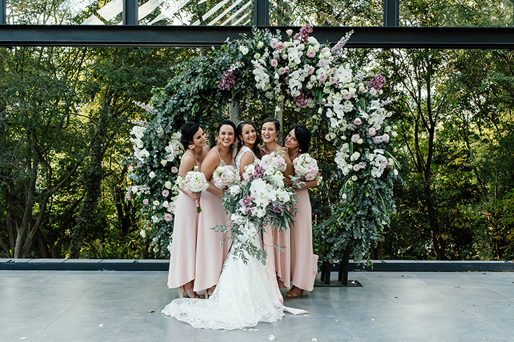 Beautiful bride smiling with her bridesmaids.
